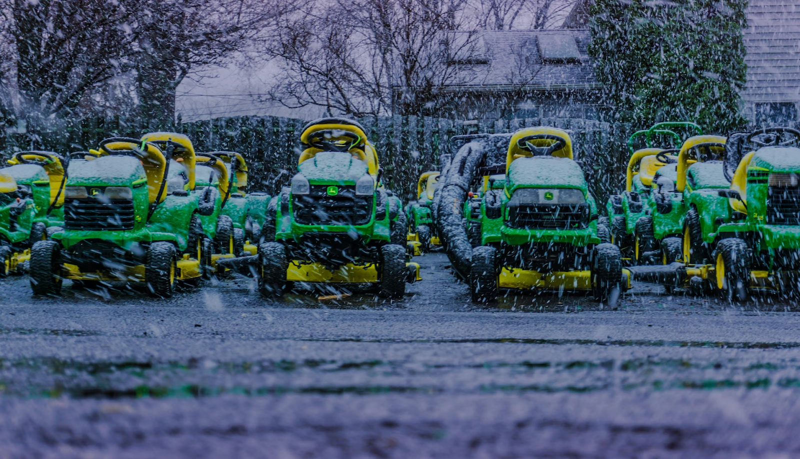 multiple mower standing during snow fall